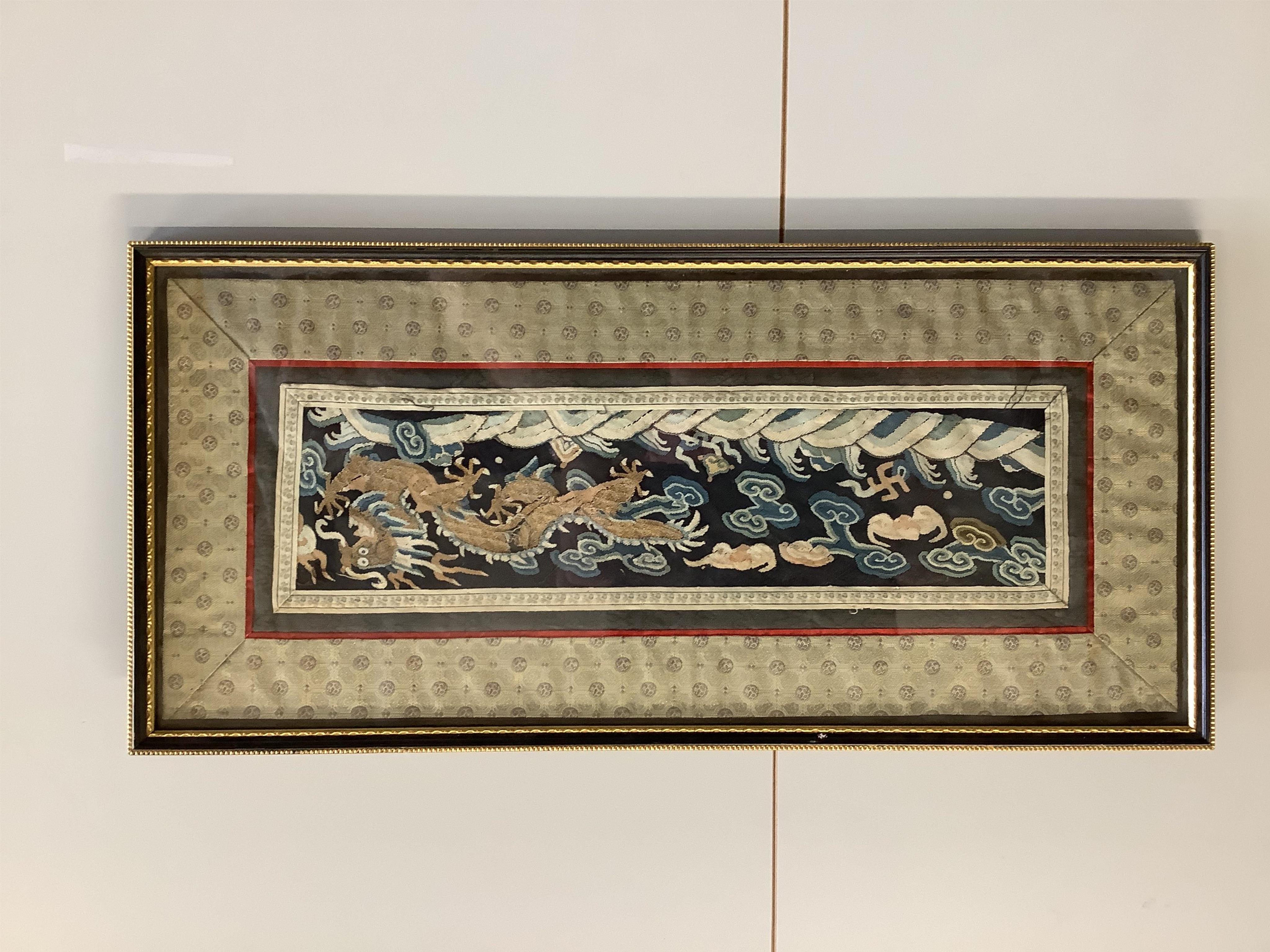 A Chinese framed Kesi gold dragon embroidery, probably originally part of a robe, together with a Chinese framed silk embroidered butterfly sleeve band, both items edged with narrow silk braiding and bordered with silk b